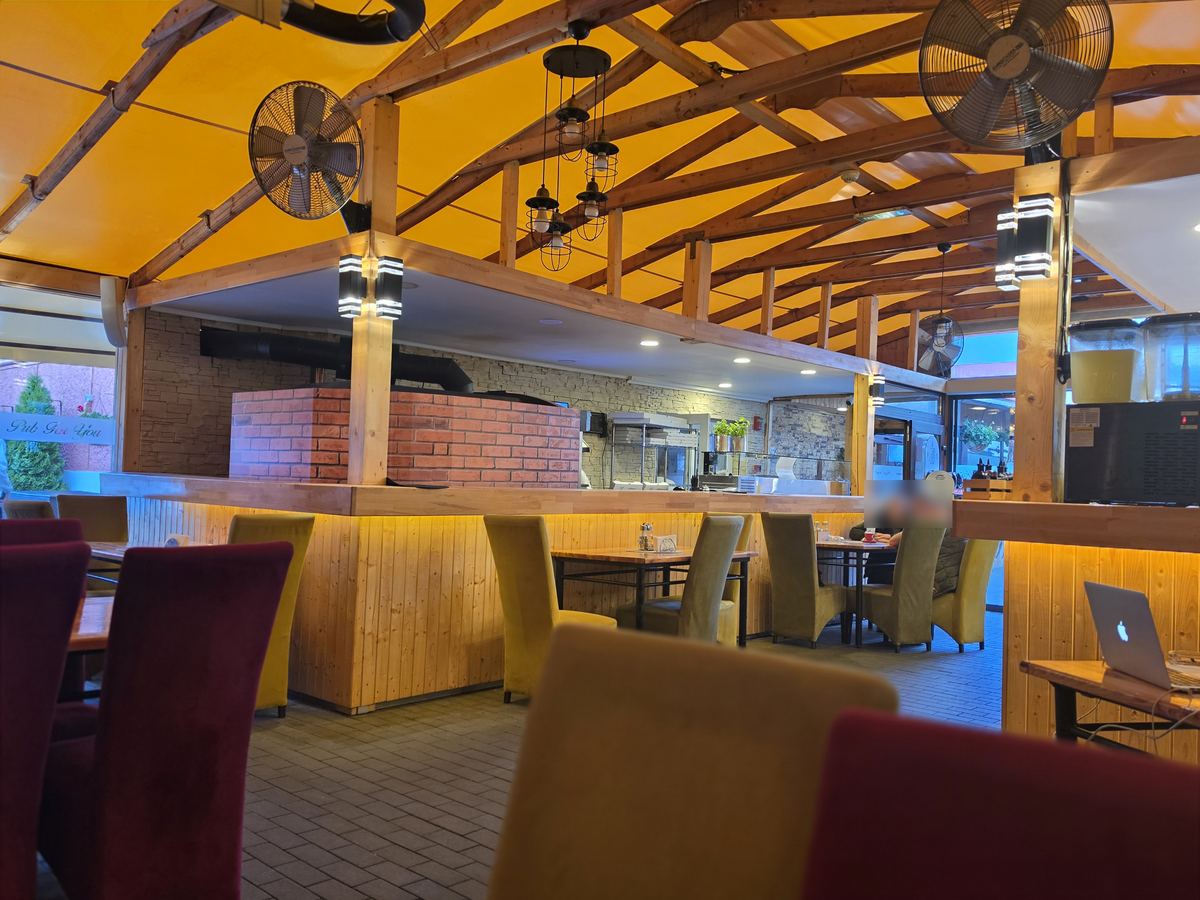 Terasa acoperită a restaurantului Pub For You din Târgu Secuiesc, cu cuptorul de pizza pe lemne